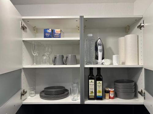 a pantry with plates and wine bottles and dishes at APARTMENT in Altendiez in Altendiez