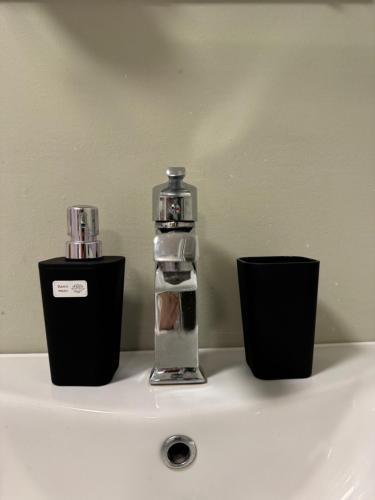 a bathroom sink with a bottle on top of it at Serenity Place in Mestia