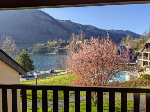 a view of a lake from a balcony at Appt T3 calme bord du lac avec piscine in Loudenvielle
