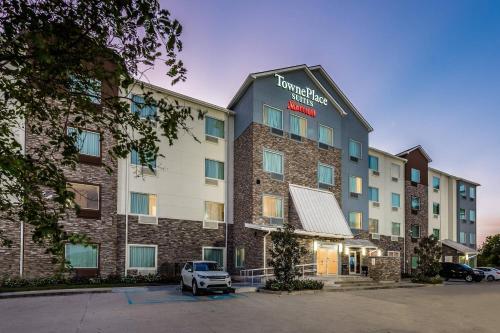 a building with a truck parked in front of it at TownePlace Suites by Marriott New Orleans Harvey/West Bank in Harvey