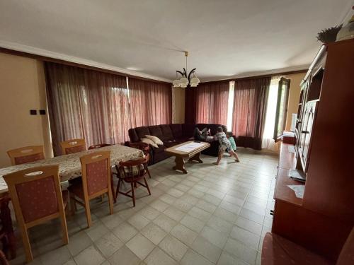 a child is playing in a living room at Kupa Villa in Balatonboglár