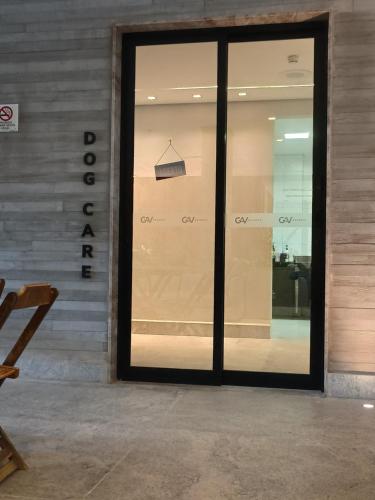 a glass door of a store with a sign on it at Salinas Premium Resort in Salinópolis