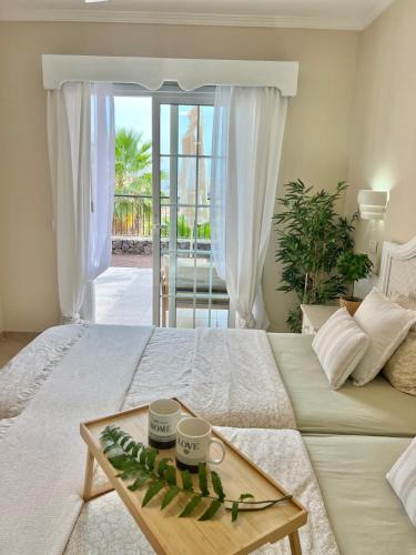 a bedroom with a bed with a tray on it at Sunny terrace & pool in Playa de las Americas