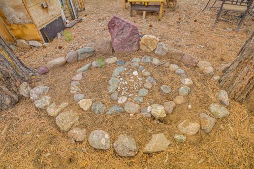 a circle of rocks and a fire pit in a yard at Near Hiking Tranquil Crestone Studio with Deck! in Crestone