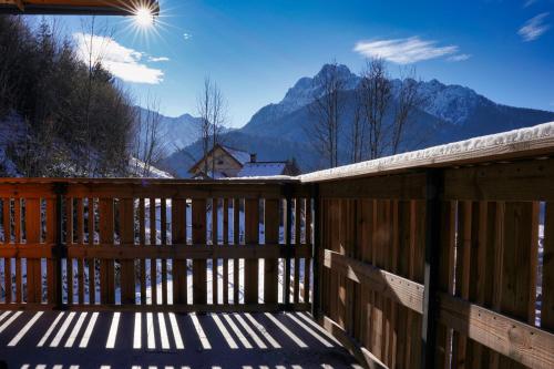 a wooden deck with a view of the mountains at Alpine Retreat house Šurc in Rateče