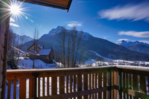 a balcony with a view of a snowy mountain at Alpine Retreat house Šurc in Rateče