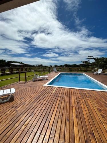 a wooden deck with a swimming pool on a house at vila sua casa 2 in Santo André