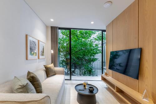 a living room with a large flat screen tv at Casa Calderon by Capitalia in Mexico City