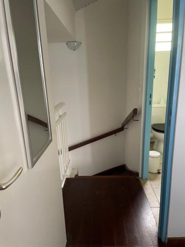 a bathroom with a toilet and a stair railing at Zen attitude in Gallochat