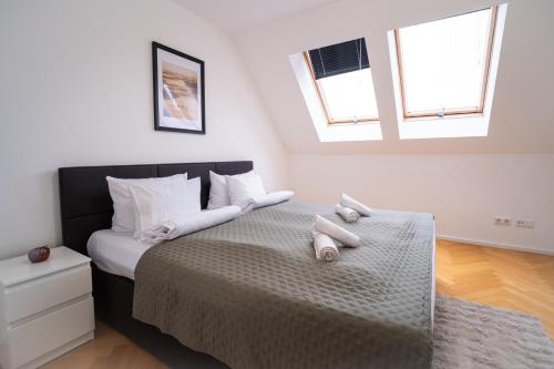 a bedroom with a bed with two stuffed animals on it at Home Sweet Home - Leopold in Vienna