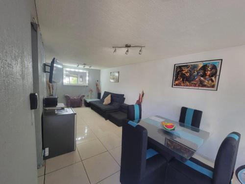 a living room with a table and a couch at Aguilas Room 1 in Guadalajara