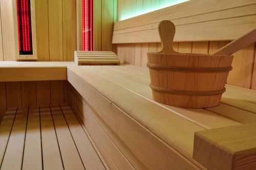 a empty cabin with a wooden bucket in it at Alpine Retreat house Šurc in Rateče