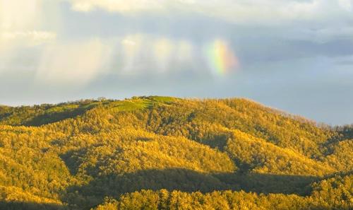 a rainbow in the sky over a mountain at Casa La Paila -- Amazing ocean & mountain views! Staff included! in Carrillo