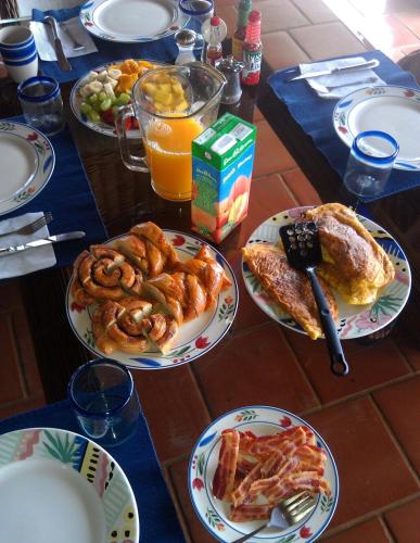 a table with plates of breakfast food on it at Casa La Paila -- Amazing ocean & mountain views! Staff included! in Carrillo