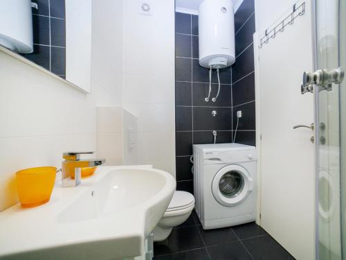 a bathroom with a toilet and a washing machine at Bel&Rus Sea Apartment in Budva