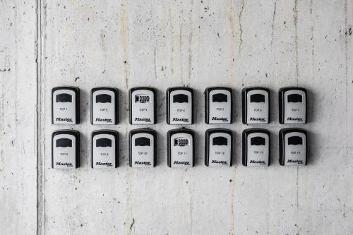 four remote controls are lined up on a wall at Berg Aparts Faschina - 13 in Fontanella