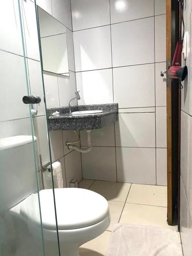 a bathroom with a toilet and a sink at Hotel Atlanta - Salvador - BA in Salvador