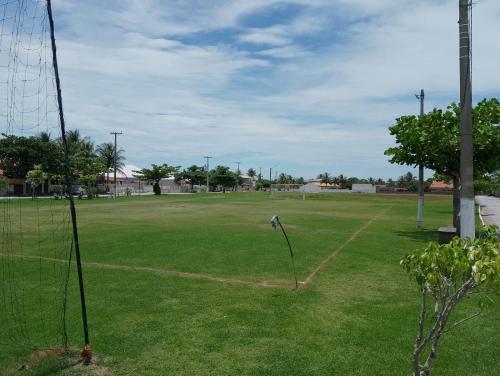 a soccer field with a net in the grass at Casa em condomínio Praia Seca in Araruama