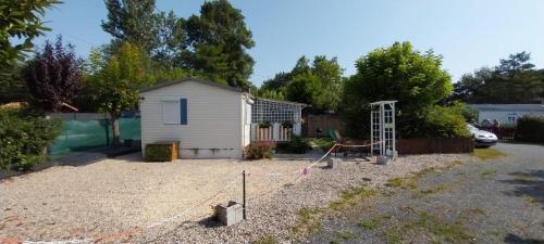 a yard with a house and a playground at Mobile home climatisé au Lac de Lougratte in Lougratte