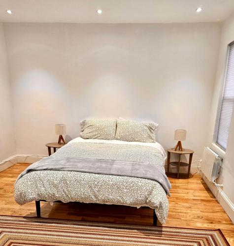a bedroom with a bed with two side tables at Jersey City Private Entire Apartment - 30 Minutes From Wall St New York City in Jersey City