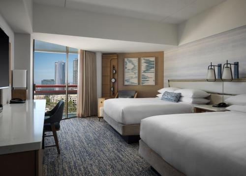 a hotel room with two beds and a desk at Marriott Marquis San Diego Marina in San Diego