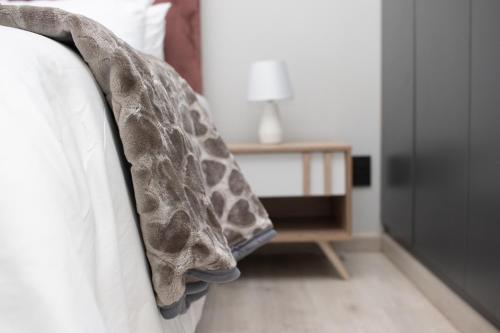 a giraffe blanket on the side of a bed at 28 Wilfred Villa in Johannesburg