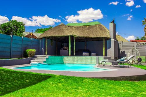 a swimming pool with a gazebo in a yard at 28 Wilfred Villa in Johannesburg
