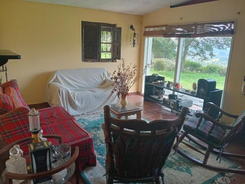 a living room with a couch and a table at La Juana Posada Campesina in Tenjo