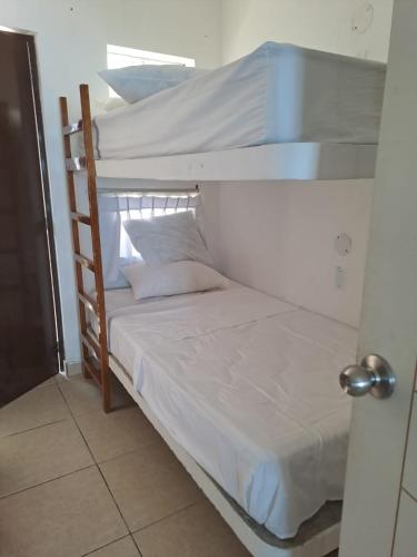 a couple of bunk beds in a room at H0TELIER Home, Máncora in Máncora