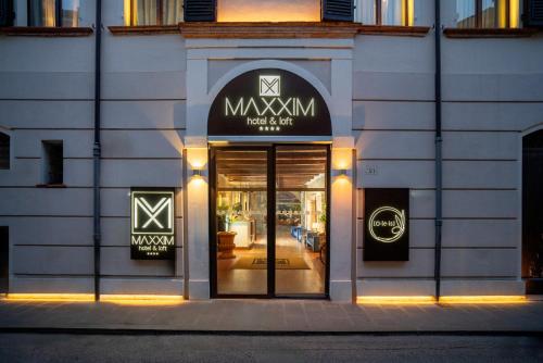 a store front of a building with the door open at Maxxim Hotel & Loft in Ferrara
