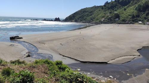 a beach with a large hole in the sand at Cabaña con acceso a playa en Mehuin in Mehuín