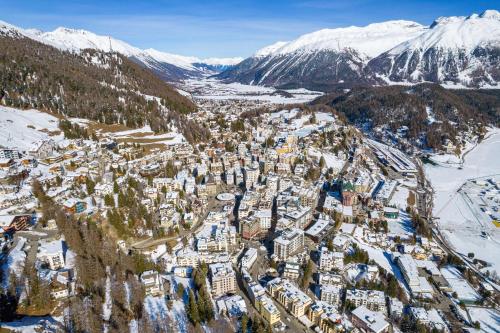 an aerial view of a city covered in snow at Grand Hotel des Bains Kempinski in St. Moritz