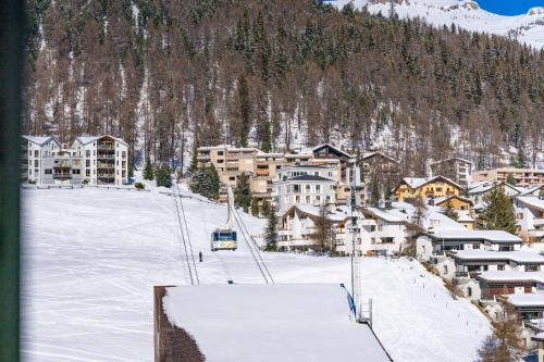 a ski resort in the snow with a ski lift at Grand Hotel des Bains Kempinski in St. Moritz