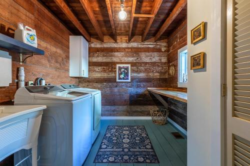 a laundry room with a washer and dryer at The School House - Walk to all Shops and Restaurants - New Remodel in Manchester