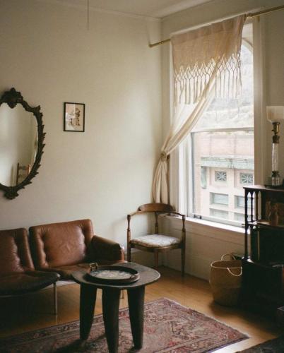 a living room with a couch and a table and a window at Object Hotel 1BR Room 3A in Bisbee