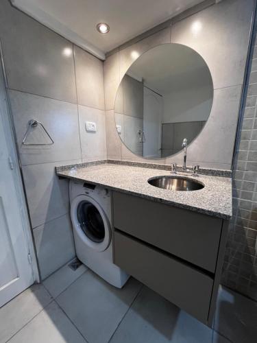 a bathroom with a washing machine and a sink at SIESTA al Lago in El Nihuil