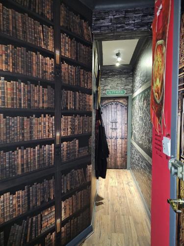 a room with a wall filled with books at Gryffindor Common Room- Warner Bros Studios & London in Watford