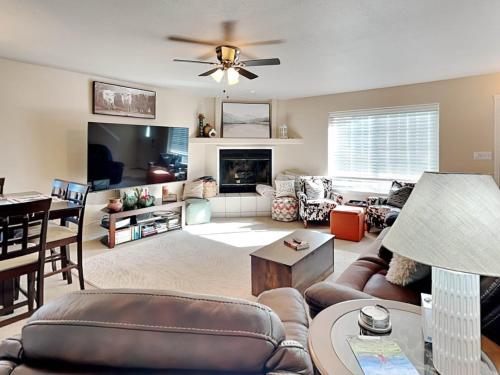 a living room with a couch and a tv at Summer Run in Ruidoso