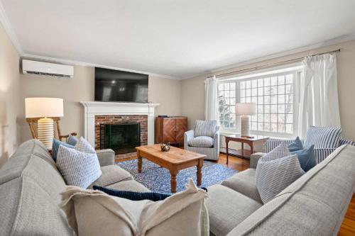 a living room with a couch and a fireplace at Pool Half Mile to Beach in Harwich