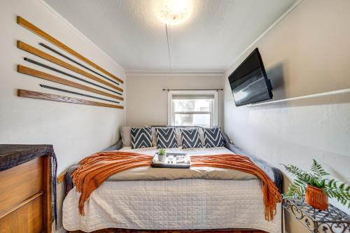 a bedroom with a bed and a tv on the wall at 1 Mi to Camels Back Park Boise Studio with Patio! in Boise