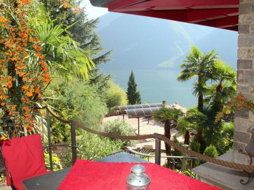 a table with a red table cloth on a patio at Barony Olive 2 Personen mit Hund in Lugano