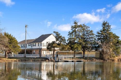 a house on the shore of a body of water at 4000 Sqft Lakefront Retreat Private Hot Tub #nh in Warr Acres