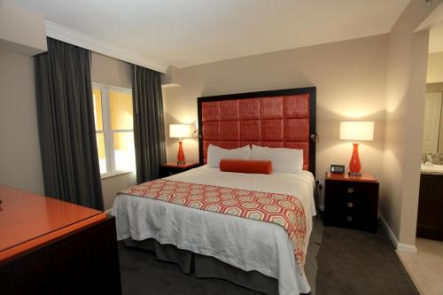 a bedroom with a large bed with a red headboard at Vacation Village at Parkway in Orlando