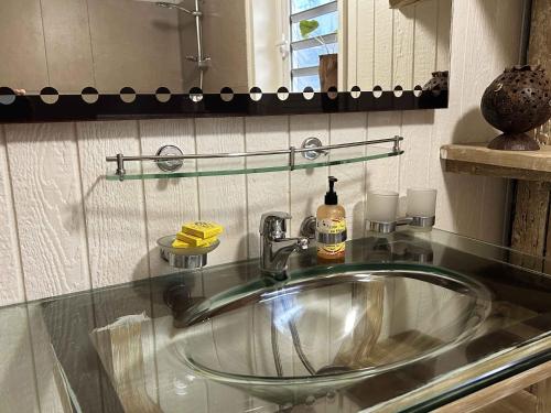 a bathroom with a sink and a mirror at Moana Waterfront Bungalow in Punaauia