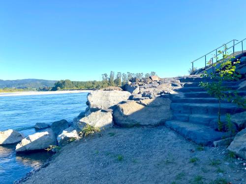a set of stairs next to a body of water at Cabañas Leufü Lodge con Tinaja in Valdivia