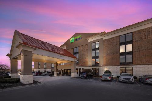 a hotel with cars parked in a parking lot at Holiday Inn Express Crestwood by IHG in Crestwood