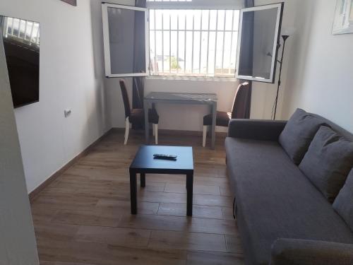 a living room with a couch and a table at Vista Puerto Ground Floor No Balcon in Arguineguín