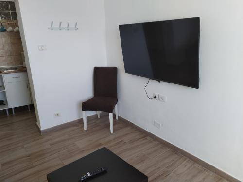 a living room with a flat screen tv on a wall at Vista Puerto Ground Floor No Balcon in Arguineguín