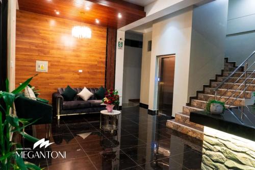 a lobby with a couch and stairs in a building at Grand Hotel Megantoni in Quillabamba
