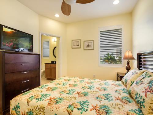 a bedroom with a bed and a dresser and a television at Island Pearl by Sun Palace Vacations in Fort Myers Beach